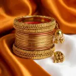 14 Pieces Gold Colored Bangles with Jhumka Tassels