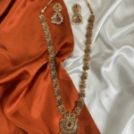 Gold Colored Haram and Jhumka with Red and Green stones