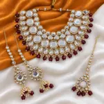 Elegant Kundan and Maroon Necklace Set with Maang Tikka and Ear Chain Jhumkas