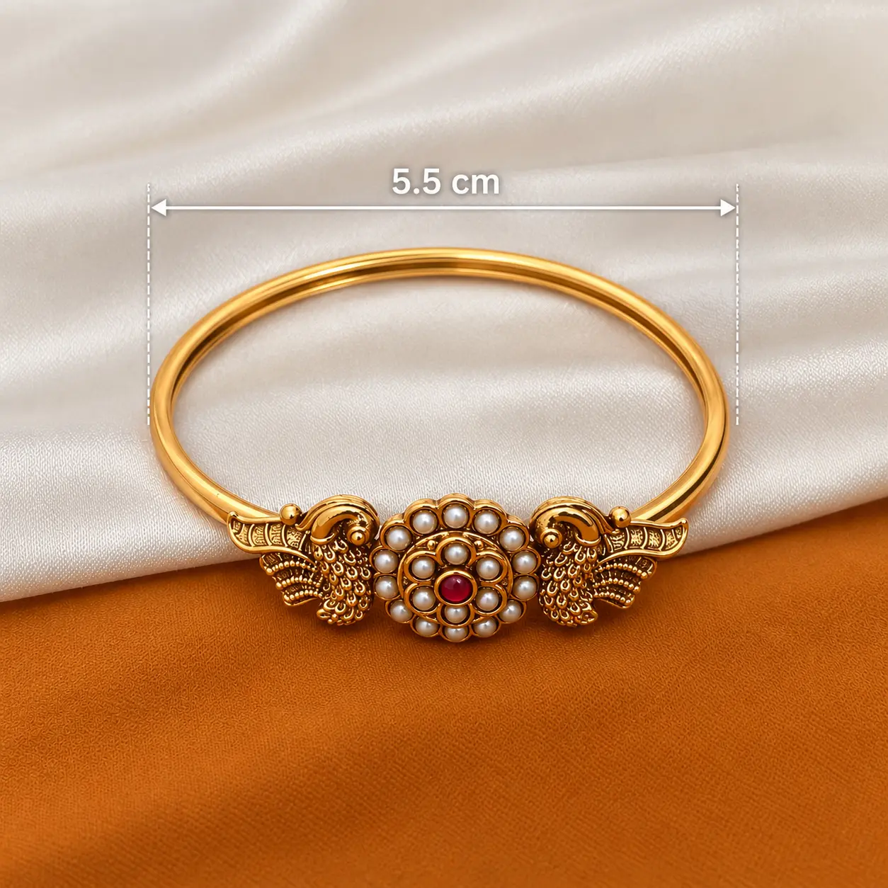 a_clean_product_studio_style_close_up_image_with_a.png Antique Gold Tone Open Bangle with Pearl & Red Stone Detail – image 3