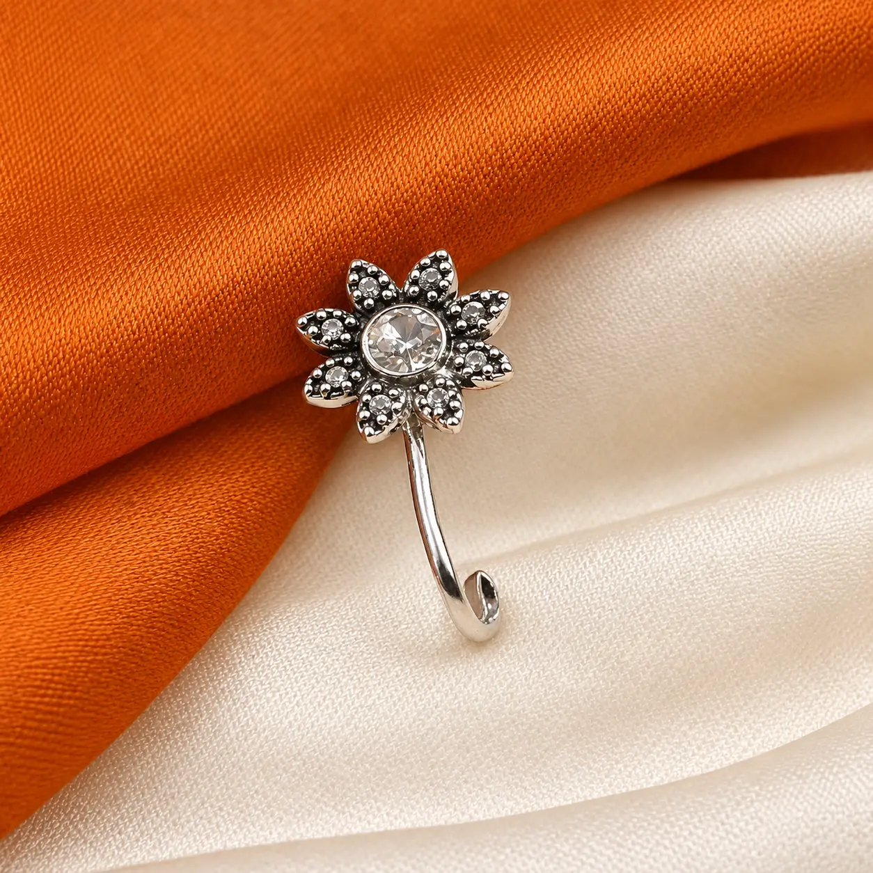 a_close_up_well_lit_product_style_still_life_phot.png Silver-Tone Floral Clear Stone Nose Pin